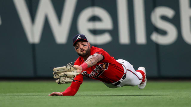 Apr 21, 2023; Atlanta, Georgia, USA; Atlanta Braves left fielder Kevin Pillar (17) catches a fly ball against the Houston Astros in the ninth inning at Truist Park.